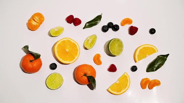 Fruits animated on white background isolated: orange, mandarin, lime, bluberry and raspberry
