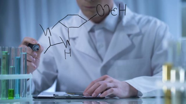 Chemist writing formula on glass and cardboard folder, research in cosmetology