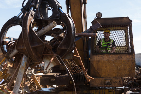 Crane lifting scrap metal in the junkyard