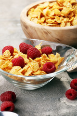 Bowl of Cornflakes and Raspberries for a healthy breakfast concept