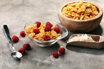 Bowl of Cornflakes and Raspberries for a healthy breakfast concept