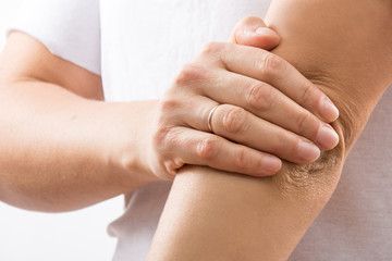 pain in elbow joint, woman with pain in elbow