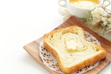 Pastry style sliced bread on wooden plate