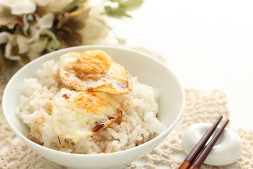 Pan fried quail eggs and soy sauce on rice