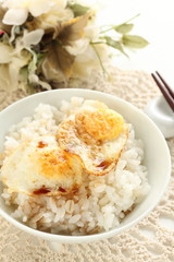 Pan fried quail eggs and soy sauce on rice