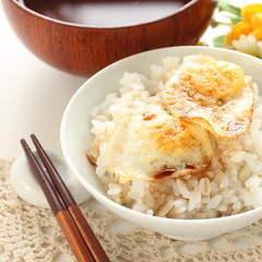 Pan fried quail eggs and soy sauce on rice