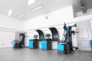Car service center interior with modern tire fitting and wheel balancing equipment