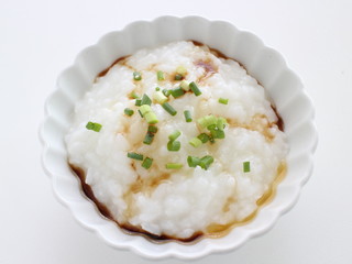 Chinese food, soy sauce and spring onion on congee