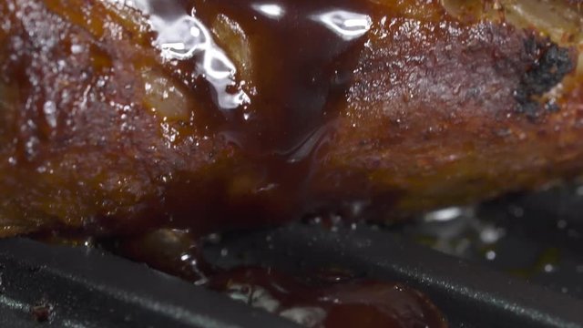 Closeup of roasting spare rib on barbecue grill