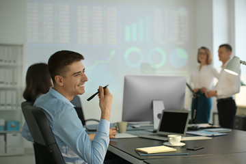 Office employees giving presentation during meeting. Forex concept