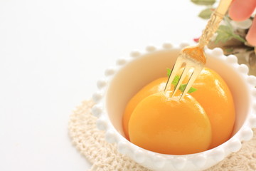 peach on bowl for dessert image