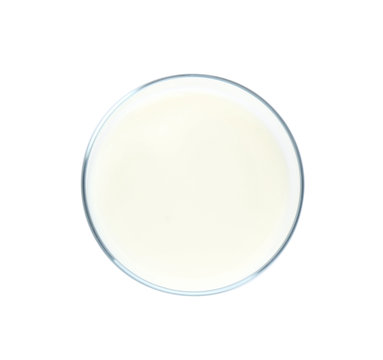 Glass with milk on white background, top view