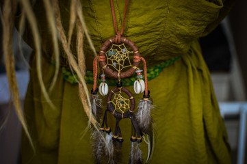 Woman with dreads wearing a dreamcatcher