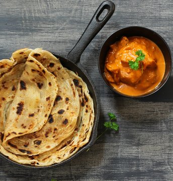Homemade Kerala wheat paratha or layered  parotta  served with Paneer curry, top view