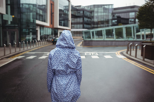 Rear view of woman standing on street