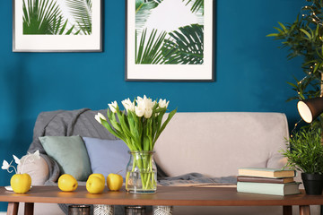 Bouquet of tulips on wooden table in living room