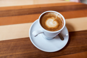 Cappuccino On Wooden Table Closeup View