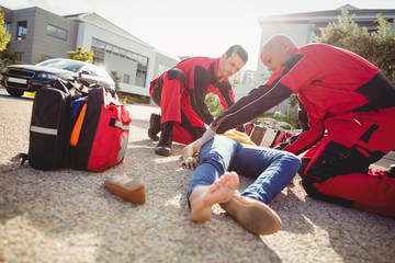 Paramedics examining injured woman