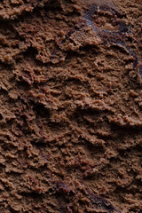 Surface of chocolate ice cream, sweet frozen dessert for summer breakfast. Photographed close-up.