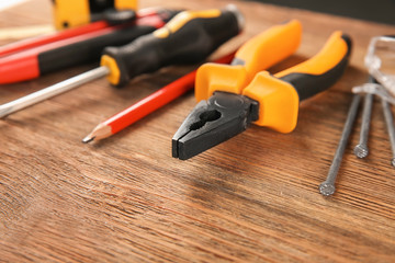 Set of carpenter's tools on wooden background