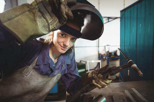 Female welder holding welding torch