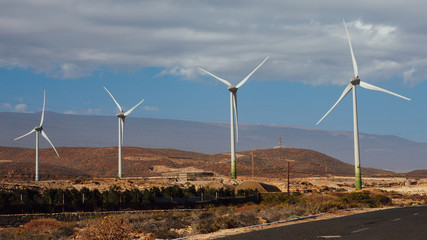 electric wind turbines farm, blue sky background