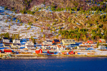 Winter views of wooden houses a long in the coast from Hurtigruten voyage, Northern Norway