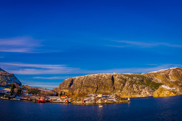 Outdoor winter views of wooden houses a long in the coast from Hurtigruten voyage, Northern Norway