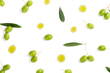 Olive oil spill and olives, above view.