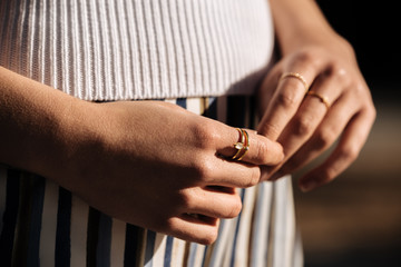 Crop woman hands with rings on the street
