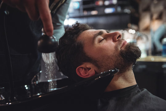 Man relaxing while getting his hair wash