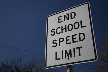 End School Speed sign against blue sky background