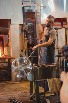 Glass blower working in workshop
