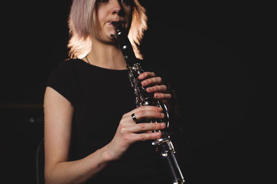 Woman playing a clarinet in music school