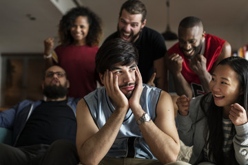 Friends cheering sport league together