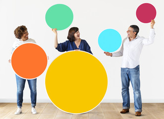 Diverse people holding colorful blank circles