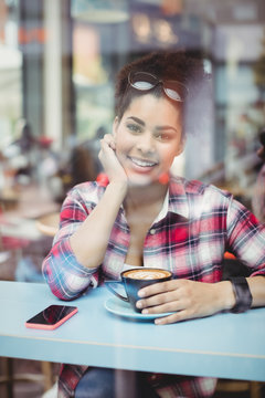 Portrait of smiling young woman at restaurant