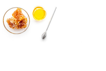 Apiary products. Honey in bowl and honeycomb on white background top view copy space