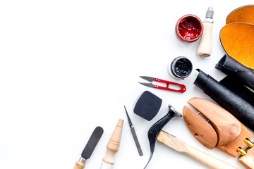 Clobber tools. Hummer, awl, knife, sciccors, wooden shoe, paint and leather. White background top...
