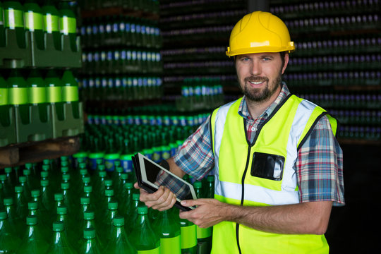 Man with digital tablet standing in warehouse