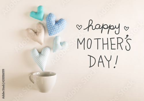 Mother's Day message with blue heart cushions coming out of a coffee cup