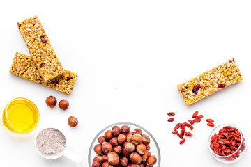 Make hearty granola bars with oatmeal, nuts, honey and berries. White background top view copy space
