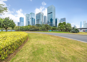 cityscape and skyline of shenzhen from meadow in park