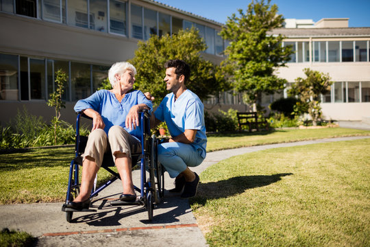 Nurse pushing the senior womans wheelchair