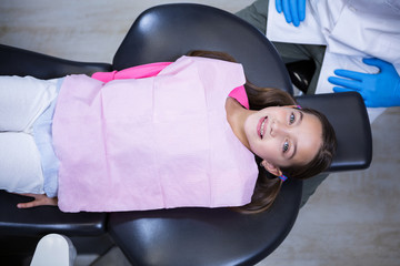 Smiling young patient sitting on dentist's chair