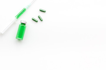 Medical therapy. Syringe, bottle with drug, pills on white background top view copy space