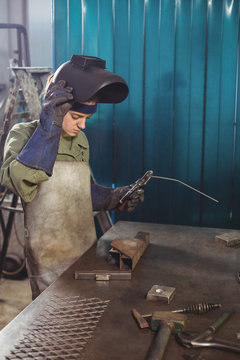 Female welder working in workshop
