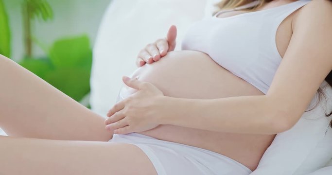 moisturizing cream on woman belly