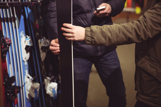 Couple selecting ski in a shop