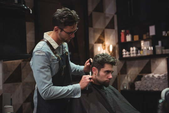 Man getting his hair trimmed with razor
